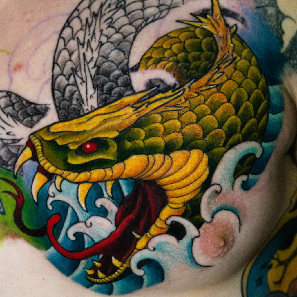 illustrative color Japanese tattoo of serpent demon with its mouth open, work in progress, done by Houston tattoo artist