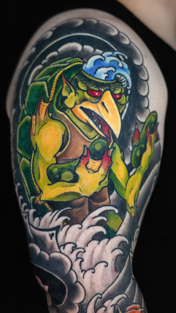 illustrative color Japanese tattoo of a kappa demon holding two pickles, done by Houston tattoo artist