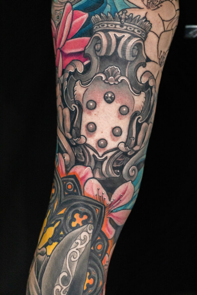 illustrative color tattoo of medici crest looking like stone, lots of greys with color surrounding