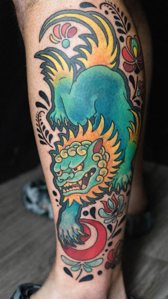 illustrative foo dog tattoo with Turkish patterns throughout, very vibrant and bold done by Houston tattoo artist