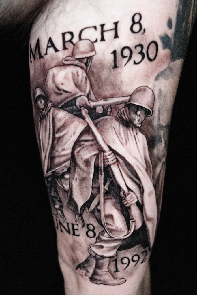 black and grey tattoo done in Houston Texas of three soldiers, date written march 8, 1930, in memorial for a soldier who fought in Vietnam