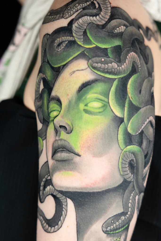 monochromatic green and grey illustrative realism tattoo of medusa, smooth shading done by a Houston tattoo artist