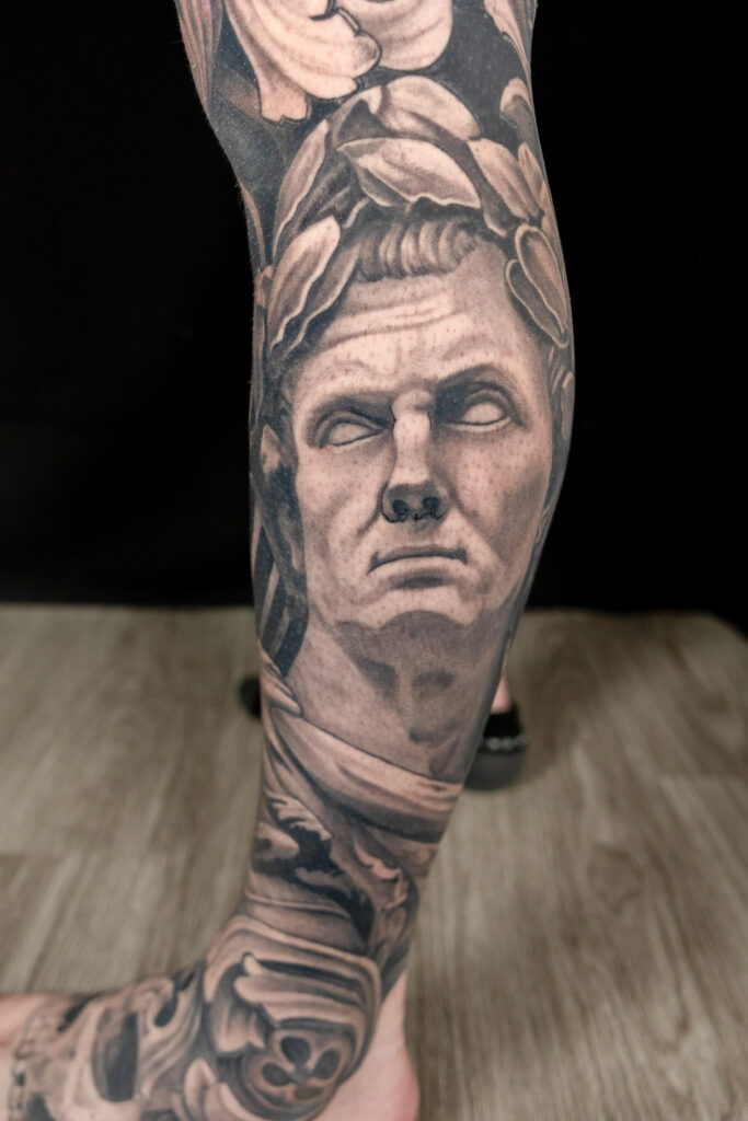 Healed, statuesque, black and grey tattoo of Julius caesar, healed, done by houston tattoo artist, smooth shading done on lower leg