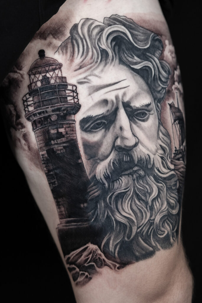 Healed tattoo of Poseidon with a fresh lighthouse. work in progress black and white tattoo on skin. done by Houston tattoo artist